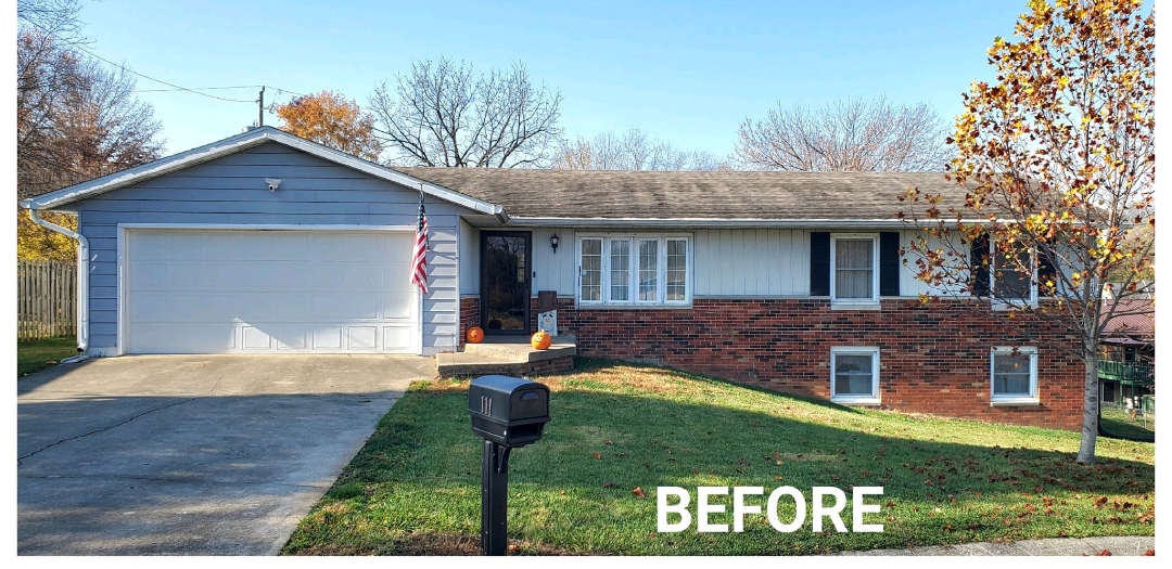 A before picture of a house with a mailbox in front of it.
