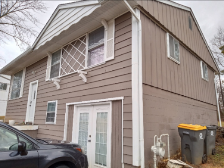 A house with a car parked in front of it