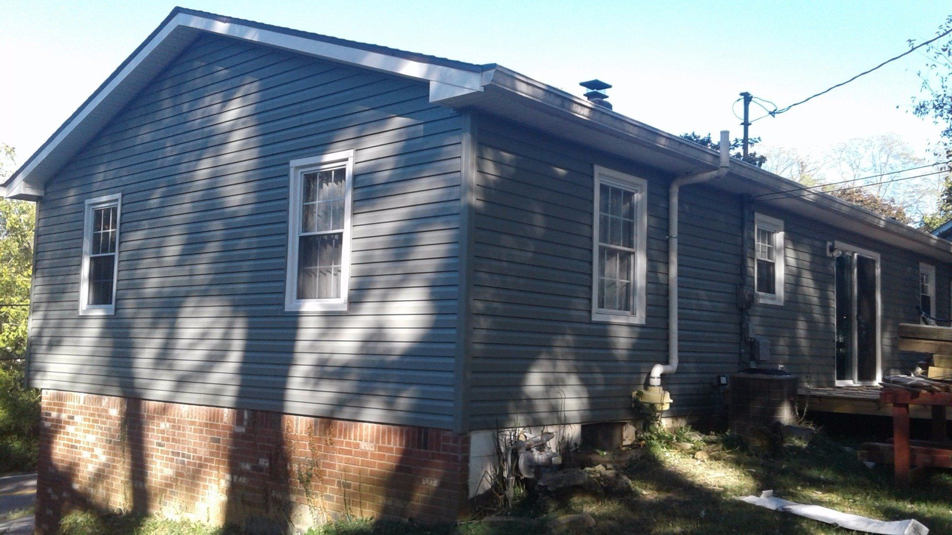 A house with a lot of windows and a roof