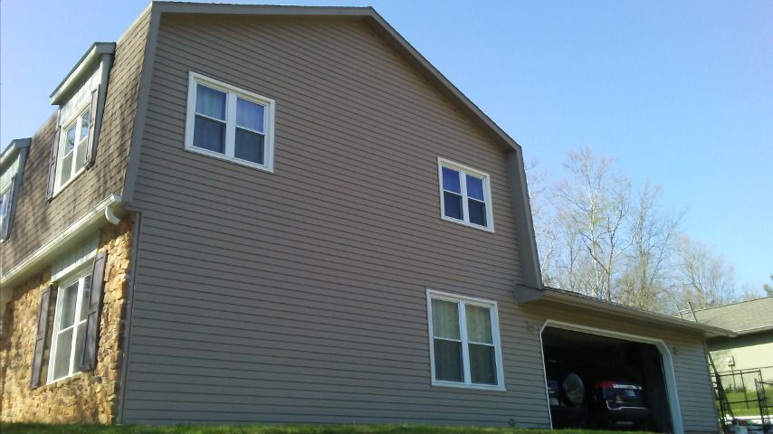 A house with a garage and a car parked in it