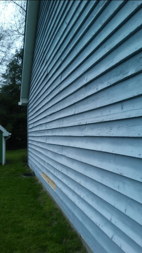 A close up of a blue siding on a house