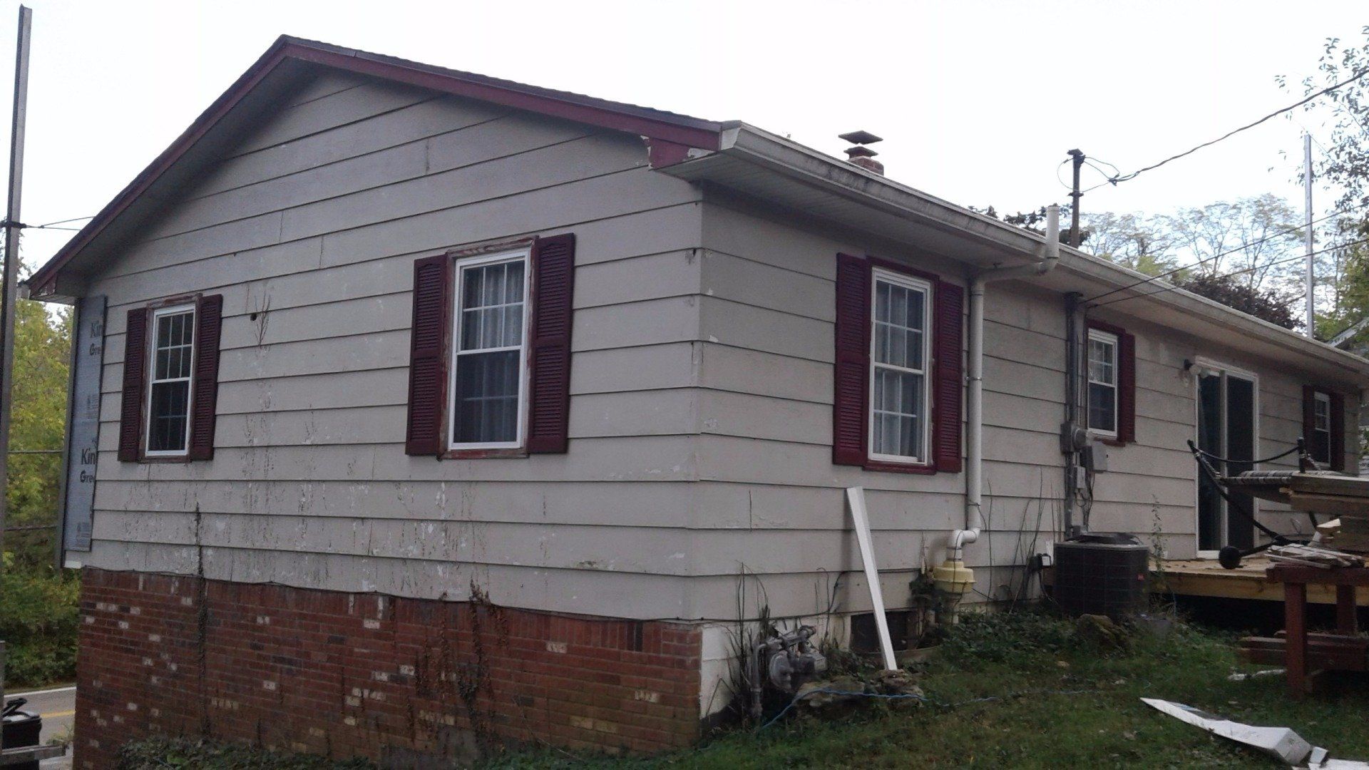 A white house with red shutters on the windows