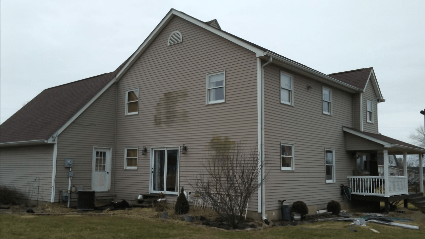 A large house with a porch and a lot of windows