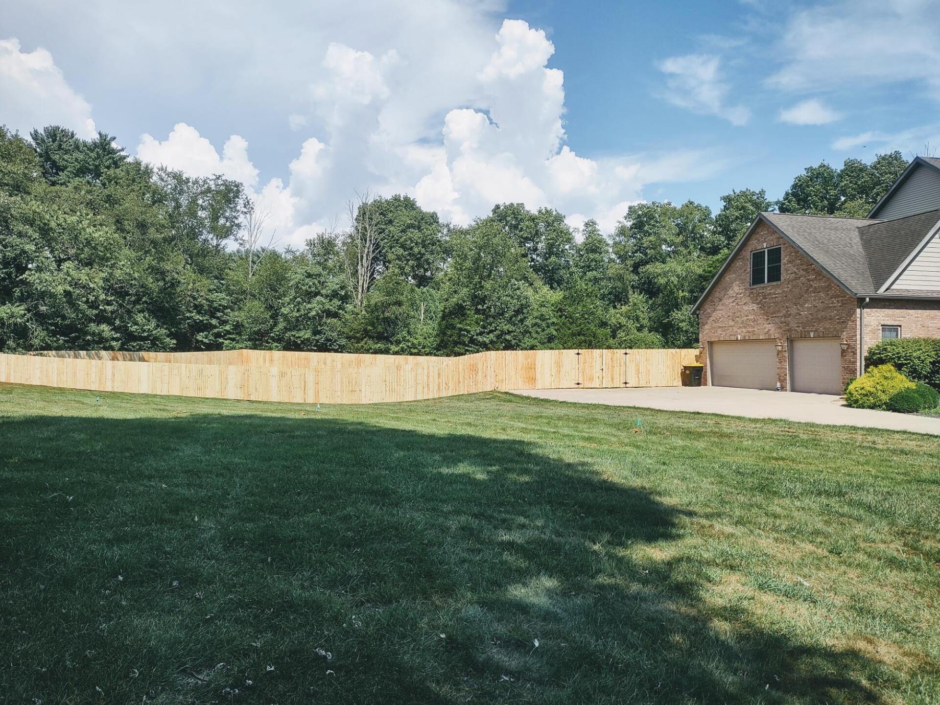 A house with a wooden fence in front of it