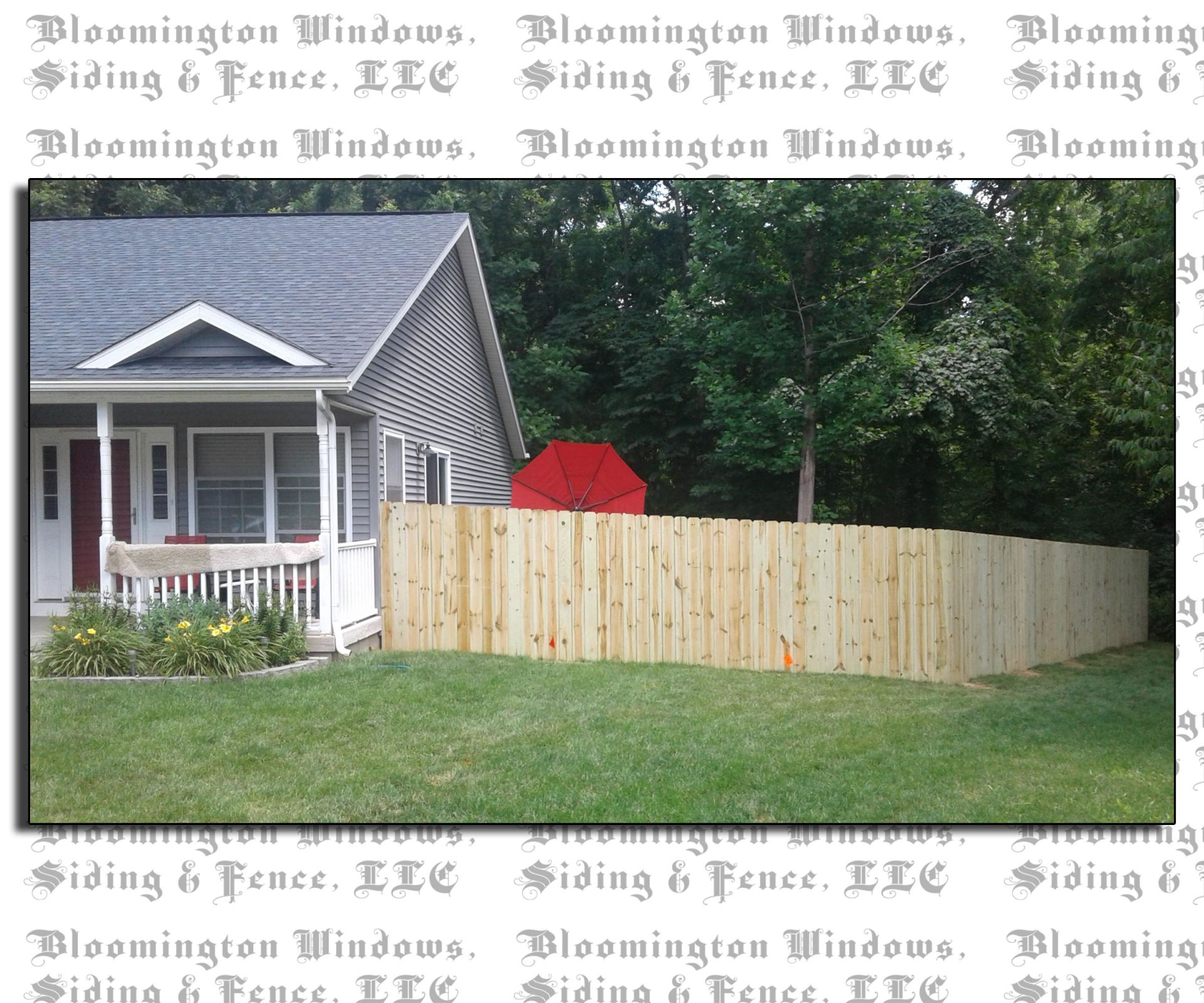 A picture of a house with a wooden fence by bloomington windows