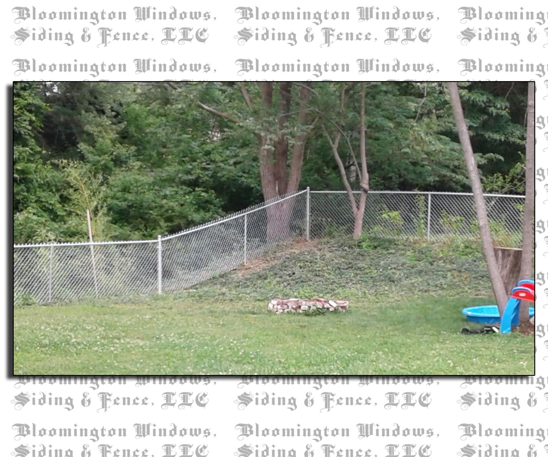 A picture of a backyard with a chain link fence by bloomington windows