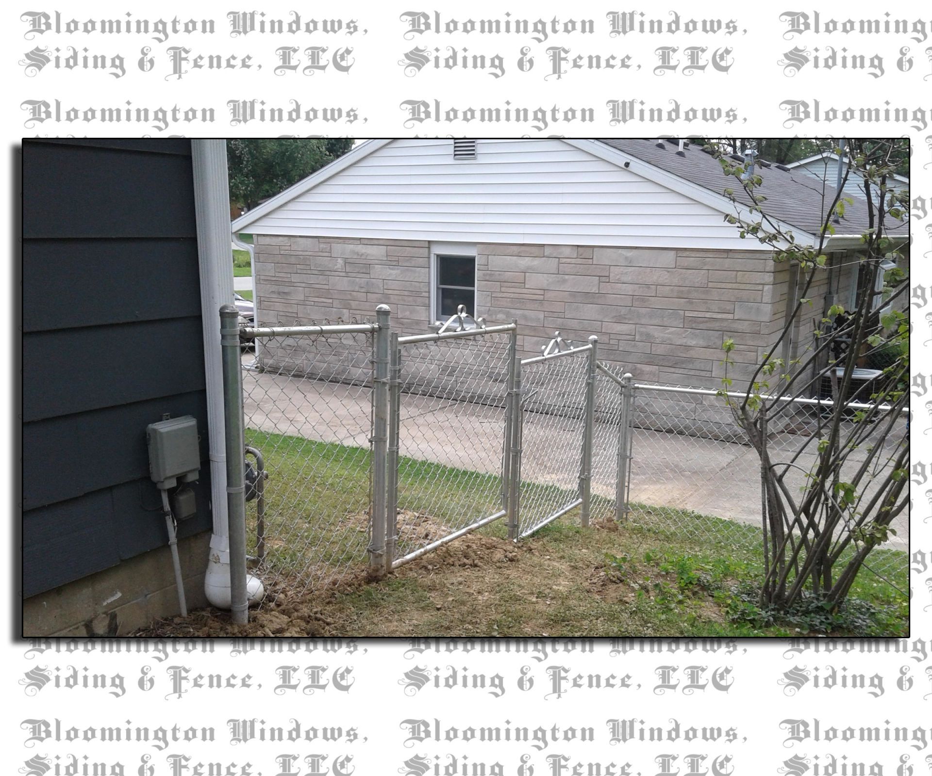 A picture of a chain link fence in front of a house