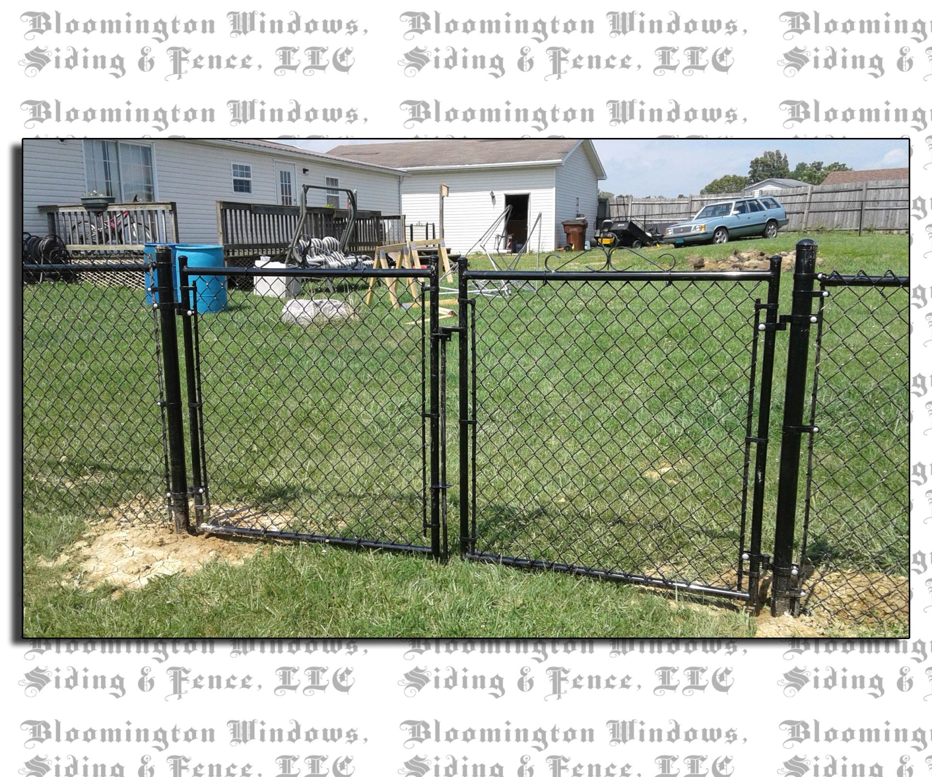 A chain link fence with a gate in a yard