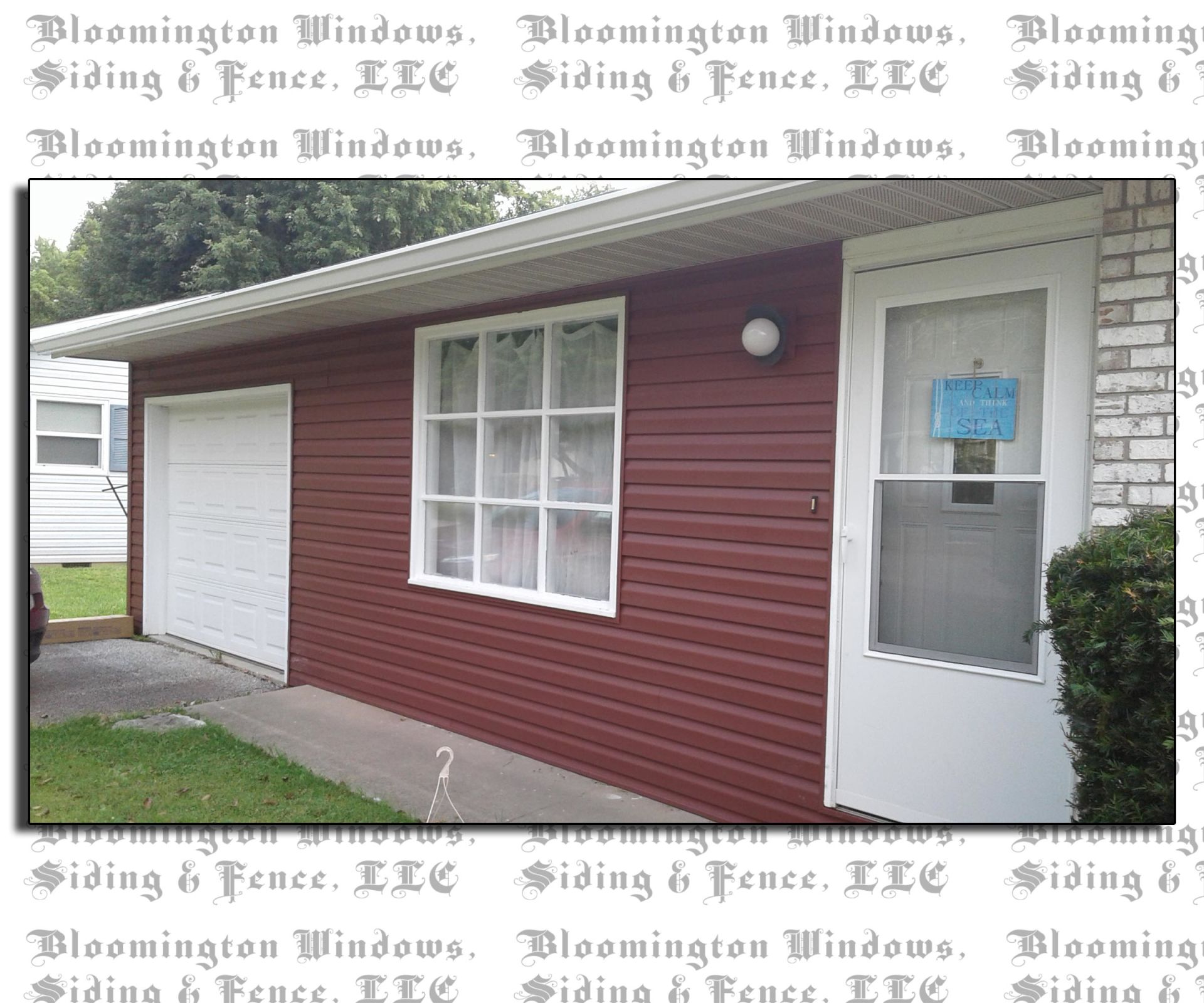 A house with a red siding and a white garage door