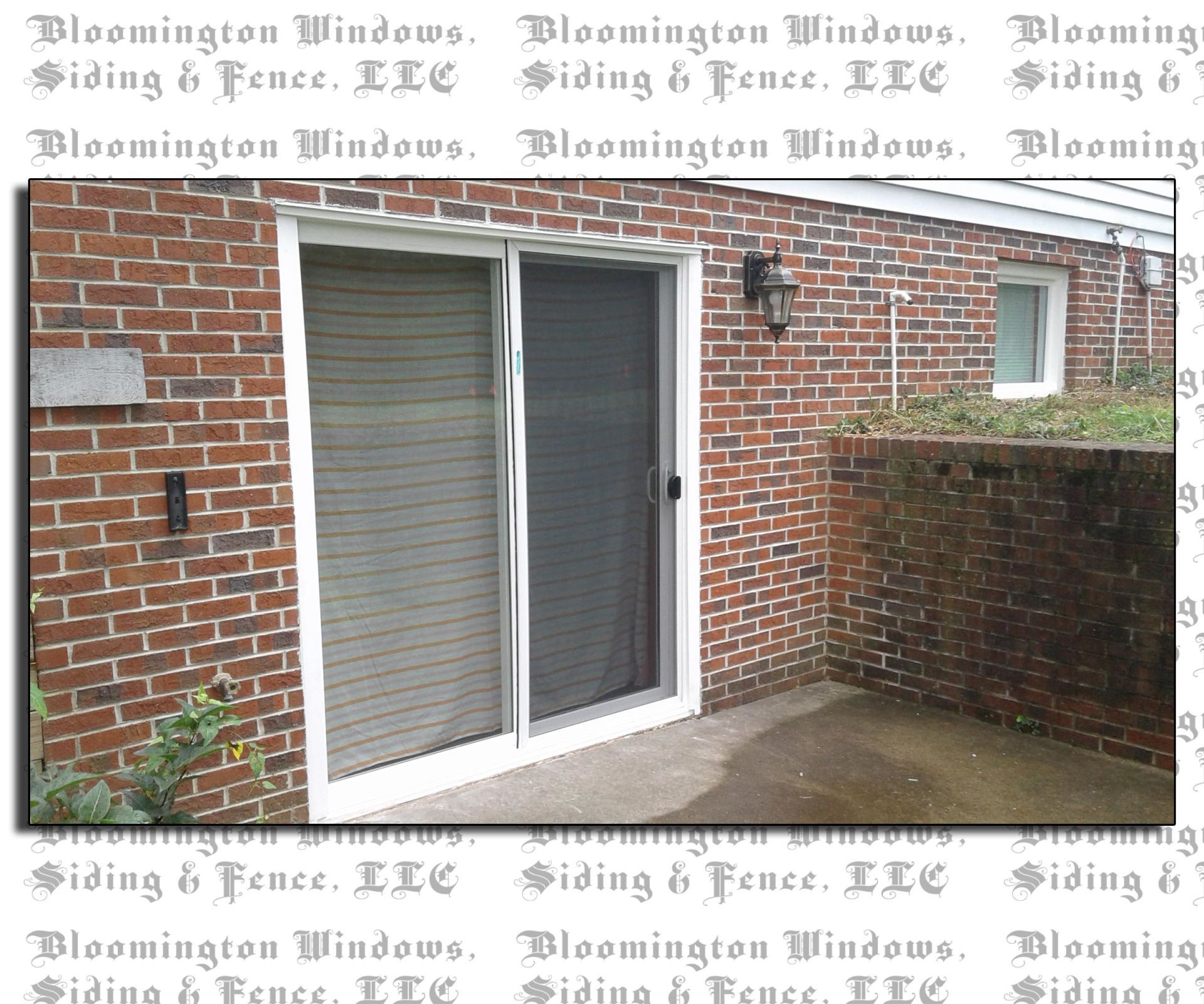 A picture of a brick building with a sliding glass door