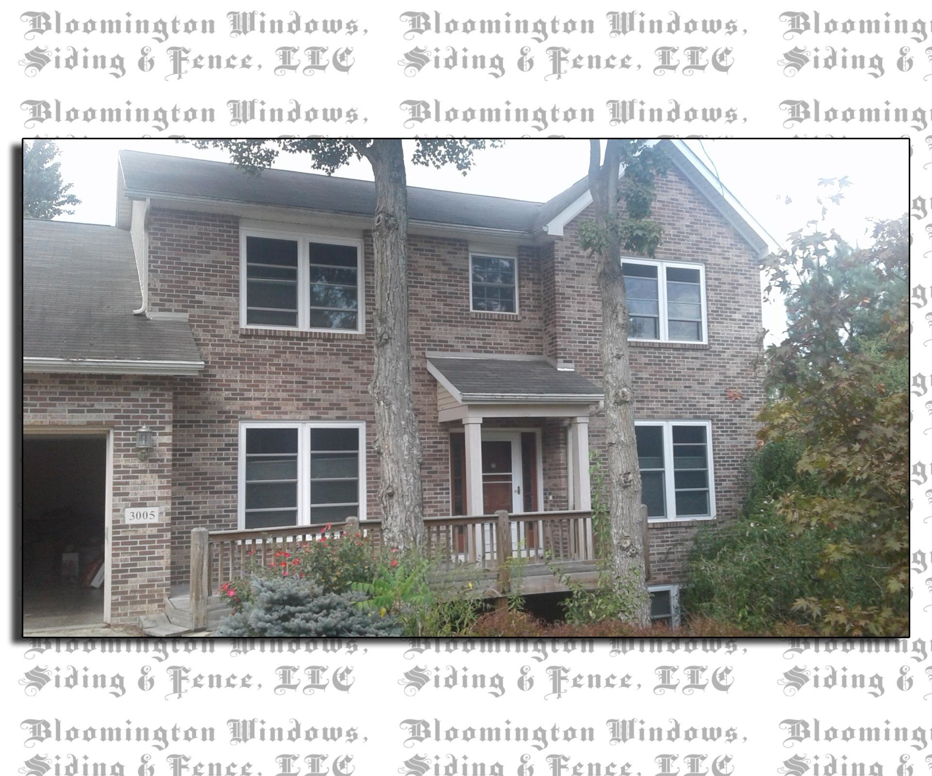 A picture of a house with the words bloomington windows siding & fence llc
