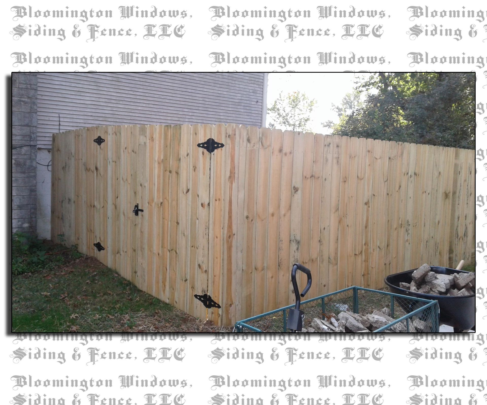 A picture of a wooden fence taken by bloomington windows siding & fence llc