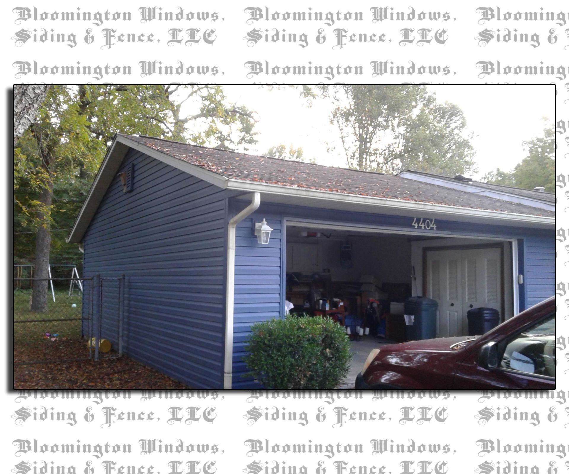 A blue garage with a red truck parked in front of it