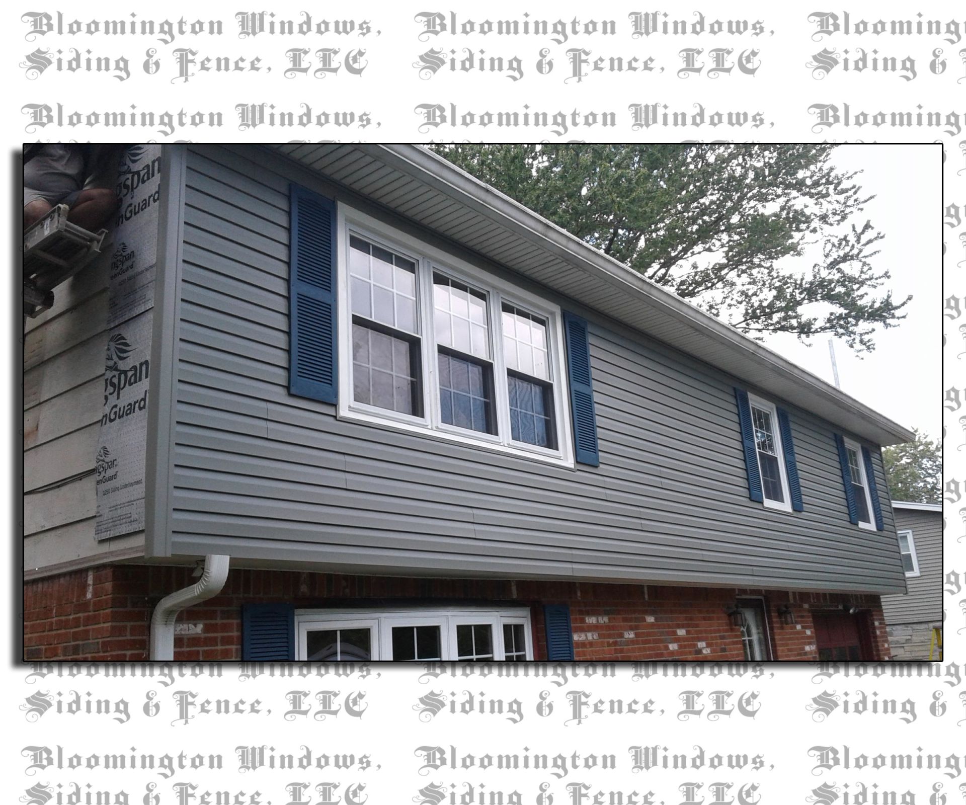 A house with blue shutters and siding from bloomington windows