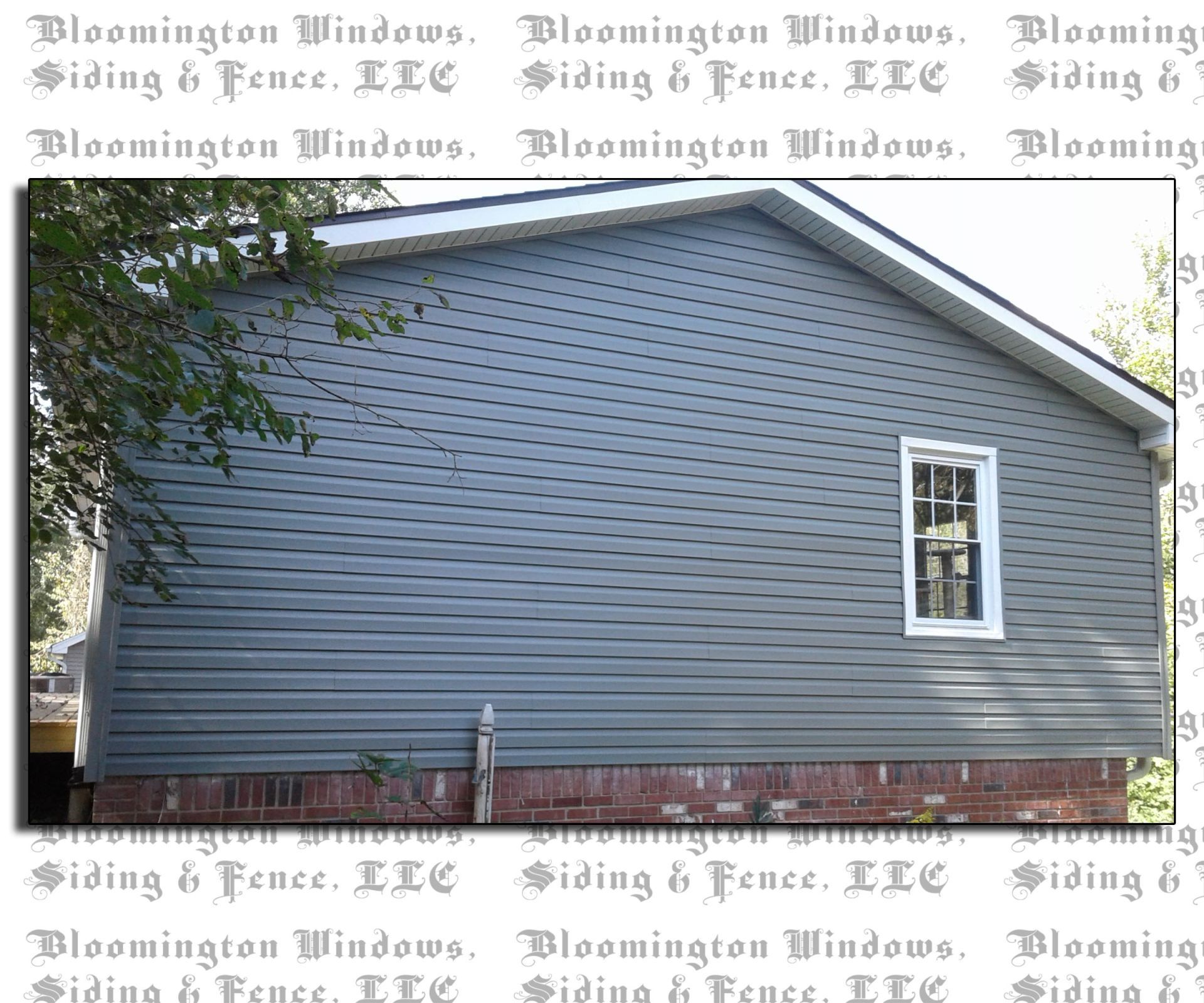 A picture of a house with siding and a window.
