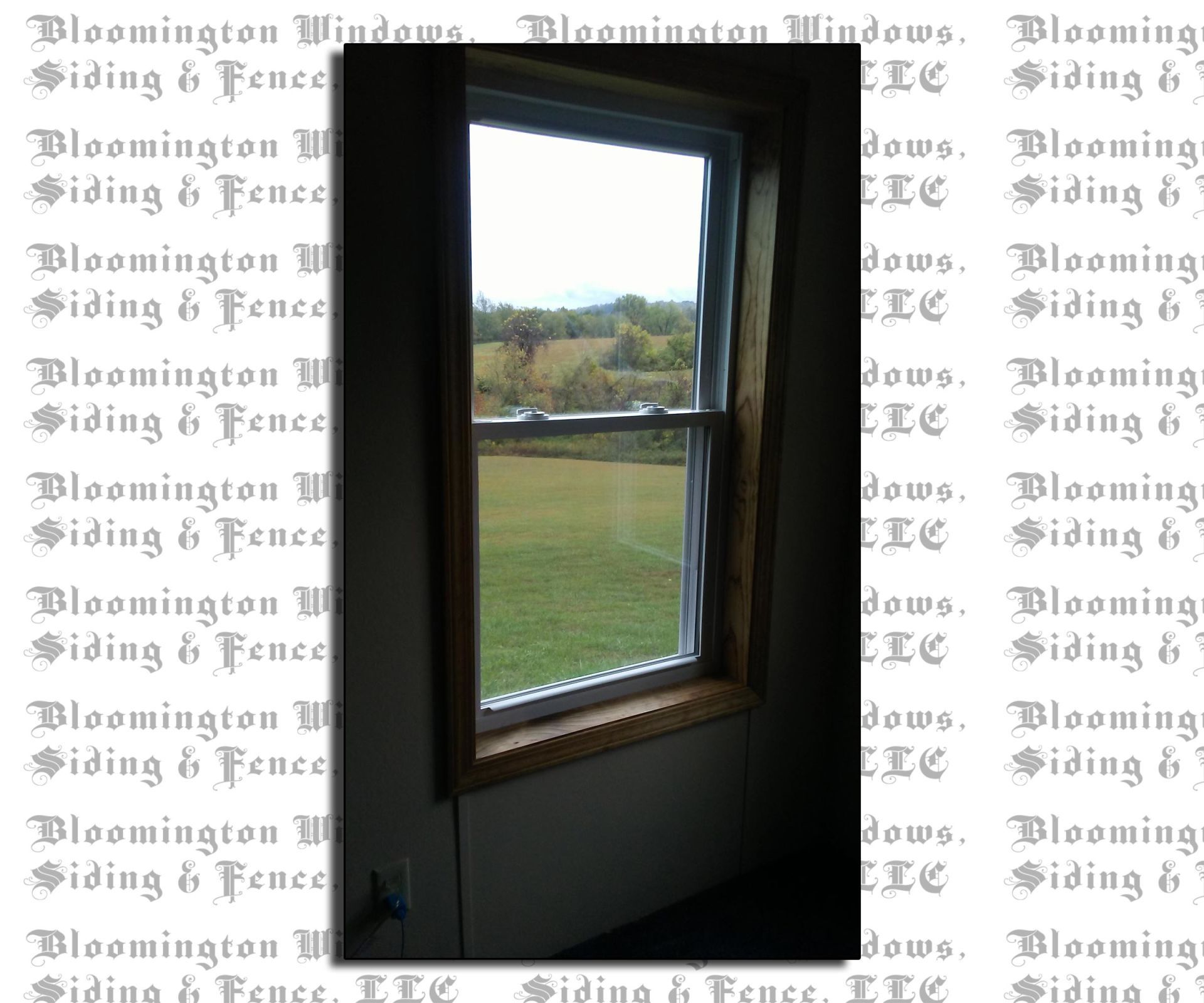 A picture of a window with a fence in the background