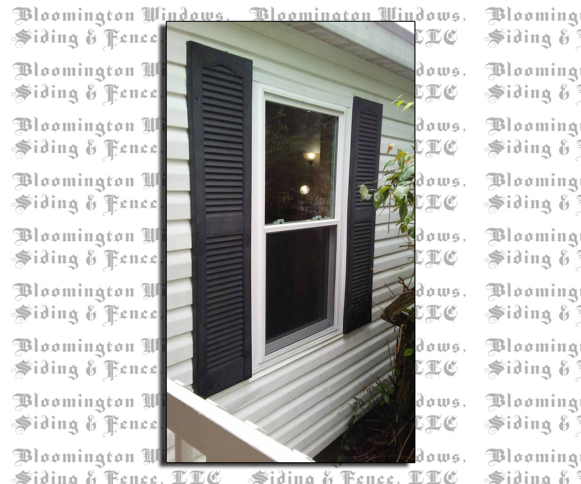 A picture of a window with black shutters on it.