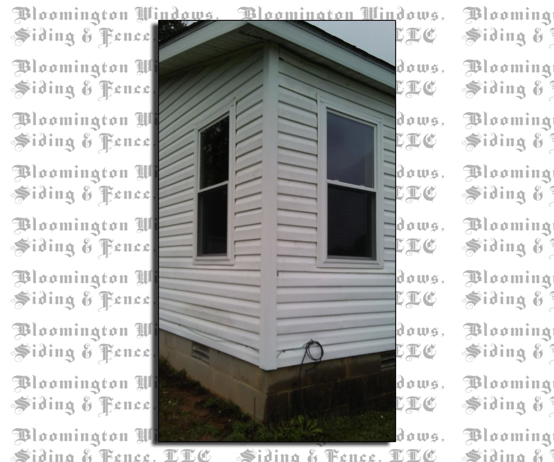 A picture of a house with a fence and siding