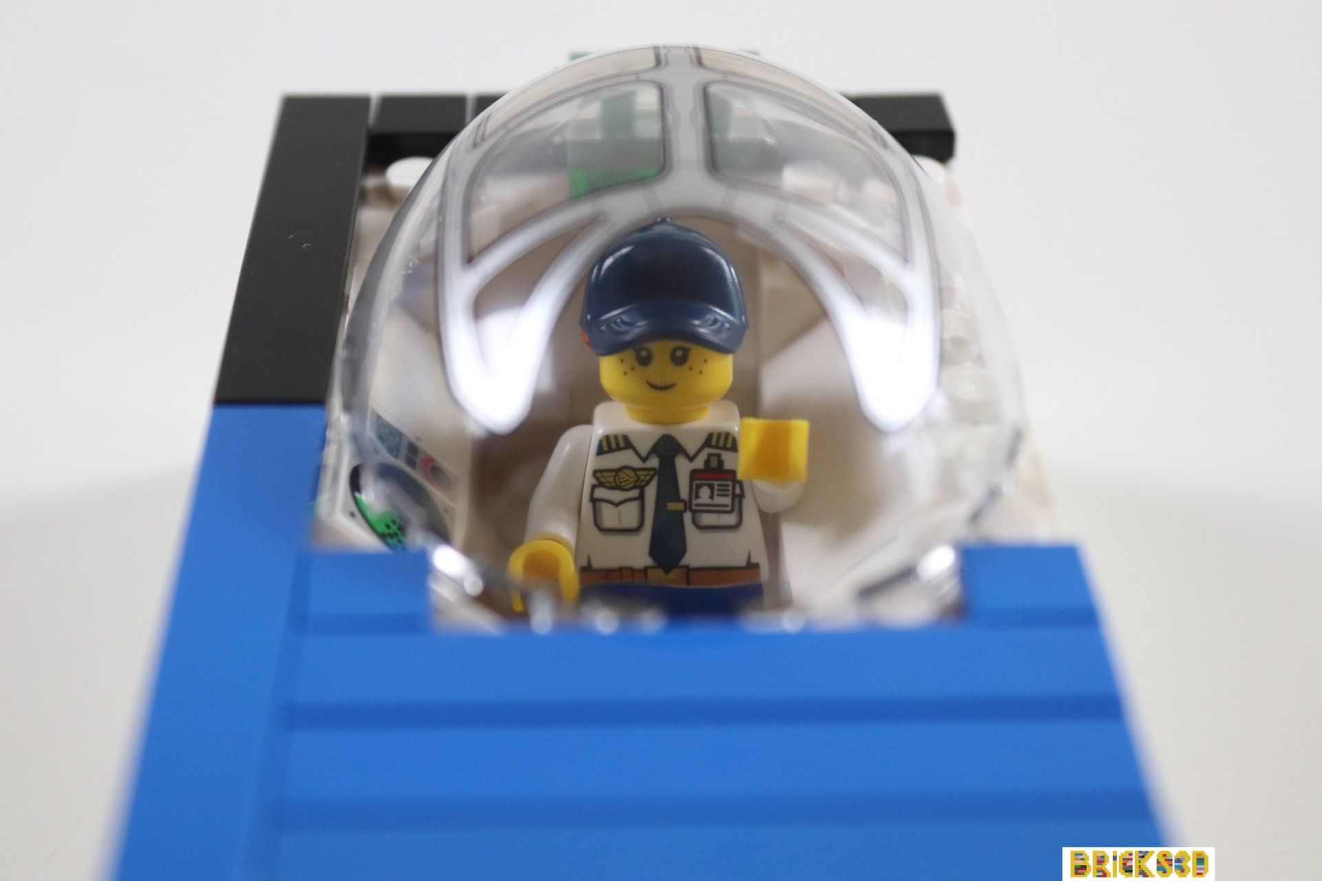 Een LEGO-mannetje zit in een glazen koepel