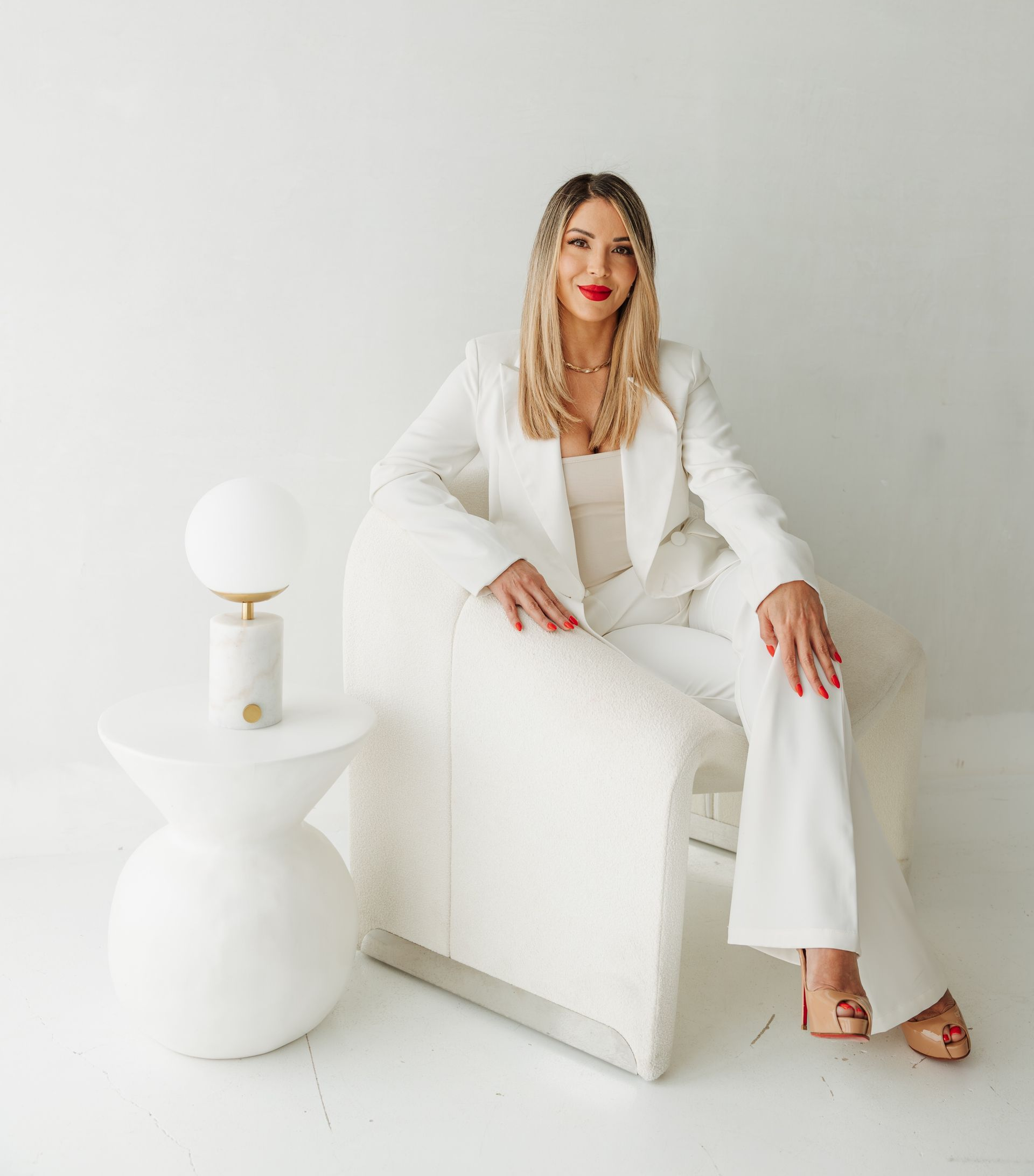 A Woman in A Lab Coat Is Holding a Syringe in Her Hand.