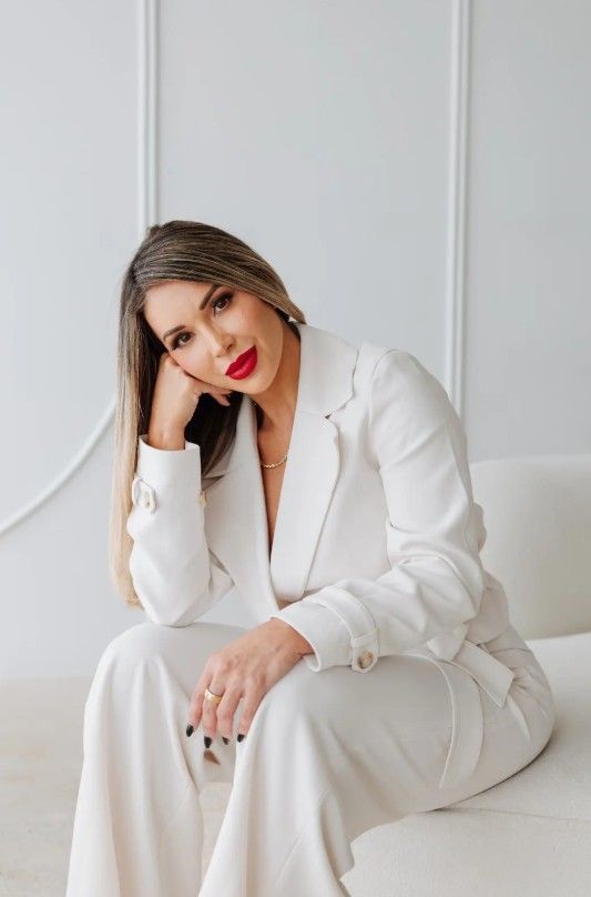 A Woman in A Lab Coat Is Holding a Syringe in Her Hand.