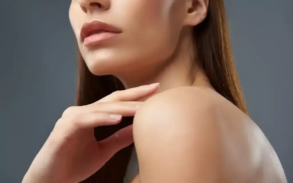 A Woman Is Touching Her Neck and Shoulder with Her Hand.