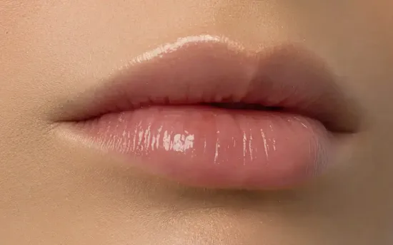 A Close up Of a Woman 's Lips with Gloss on Them.