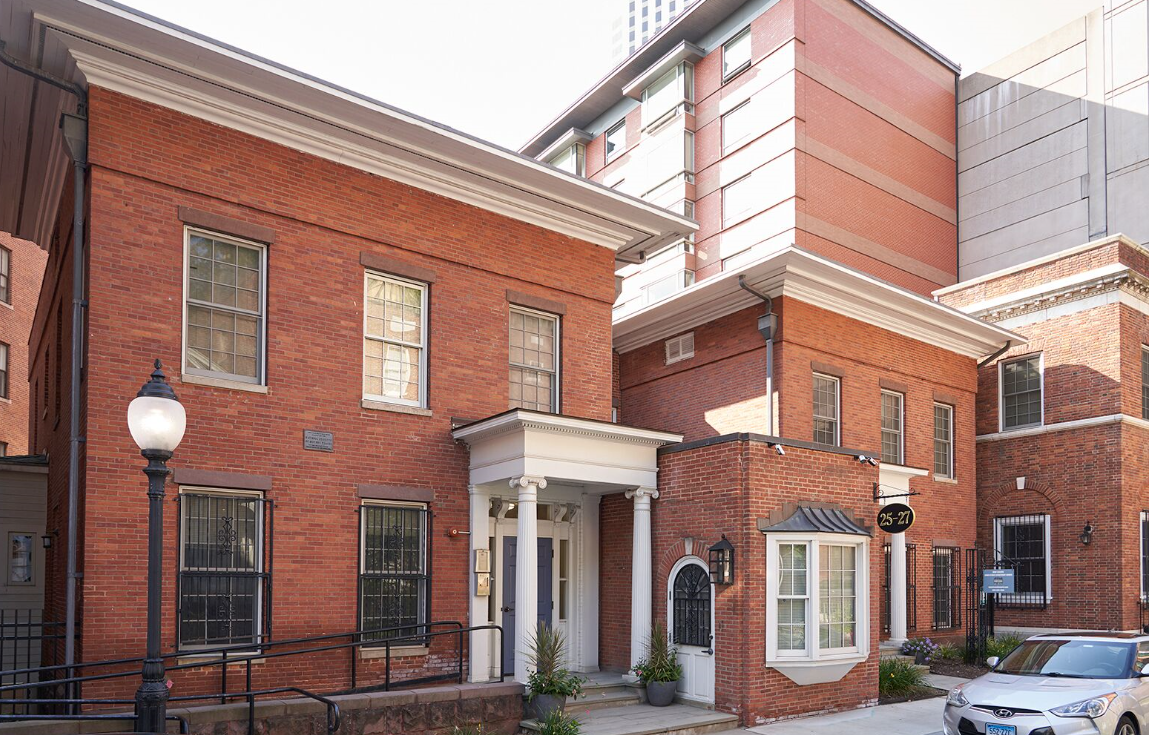 A brick building with a car parked in front of it