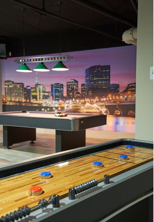 A group of chairs and a fire pit in front of a building