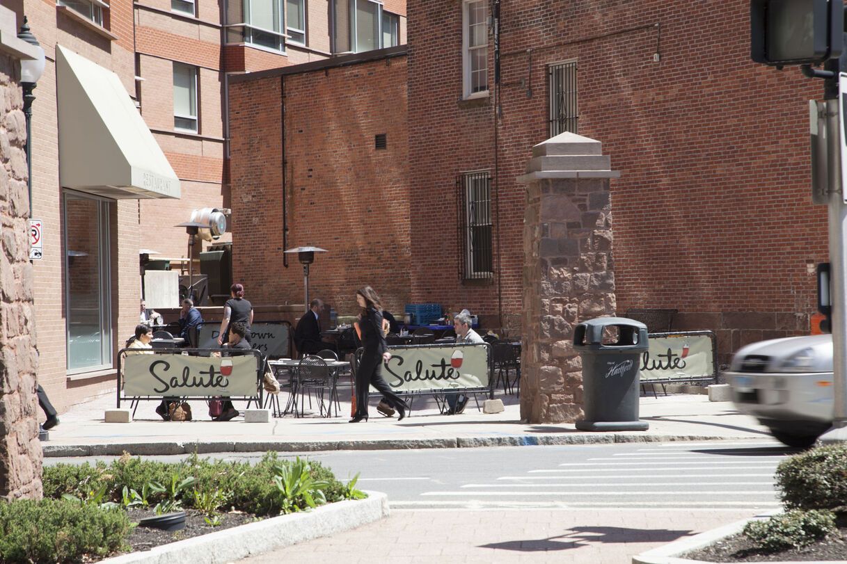 A street scene with a food cart labeled 