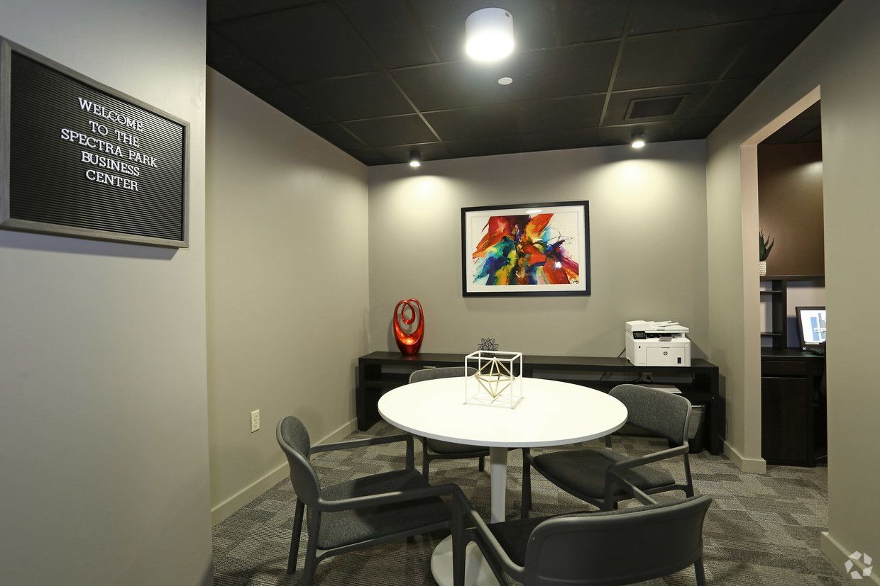 A small room with a table and chairs in it.