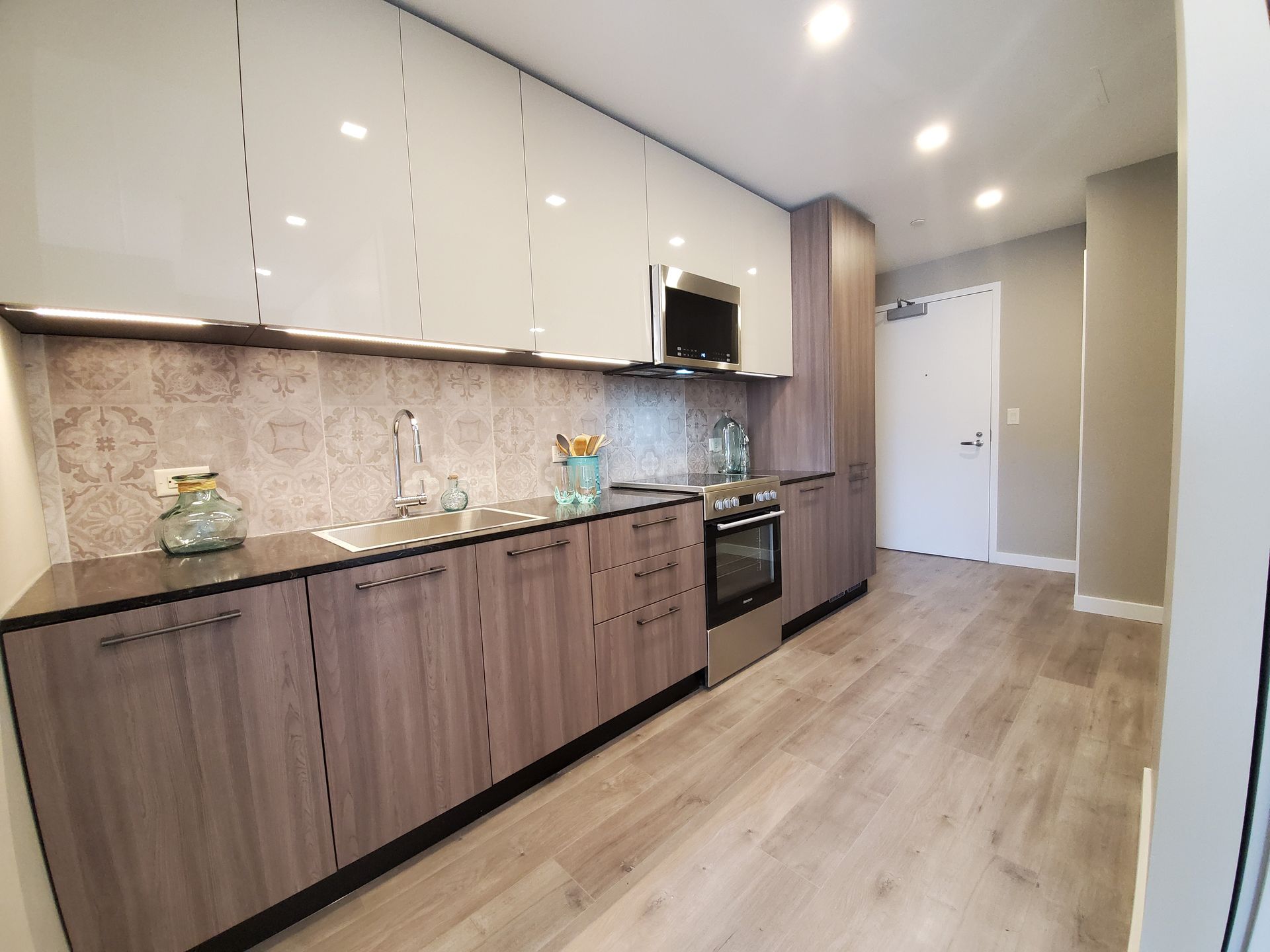 A kitchen with wooden cabinets and stainless steel appliances