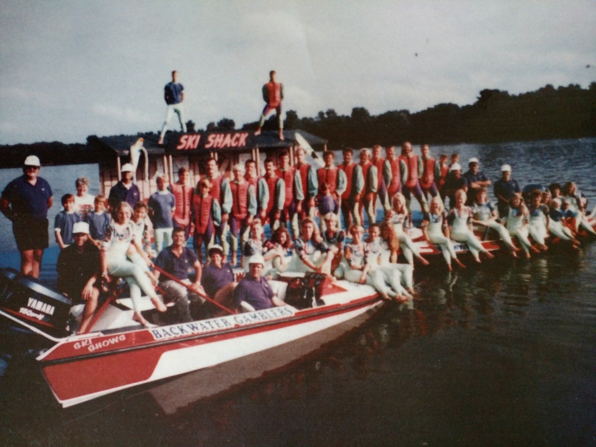 A group of people on boats in front of a ski shack