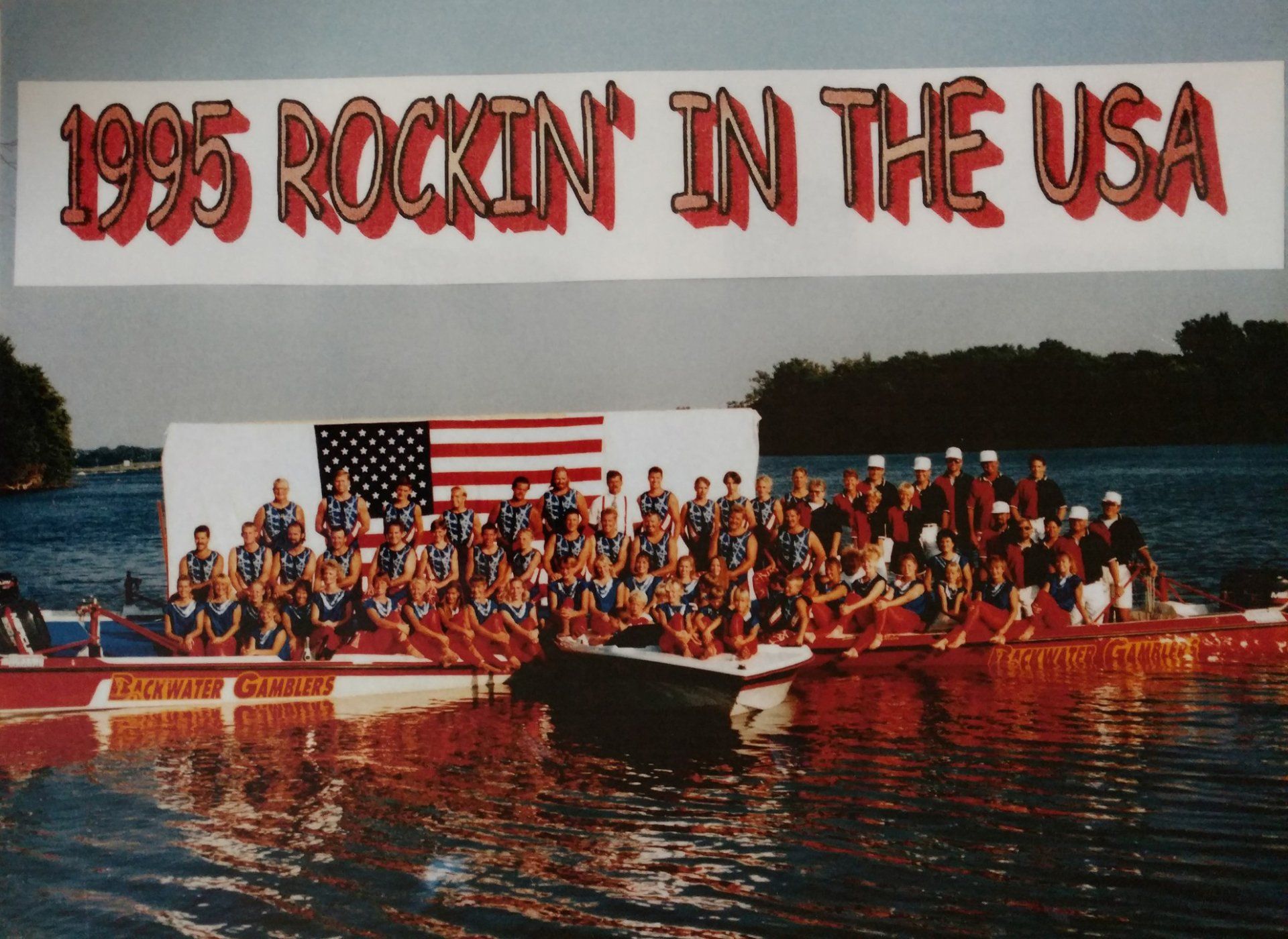 A group of people in and arounds boats with a banner that says 1995 Rockin' in the USA