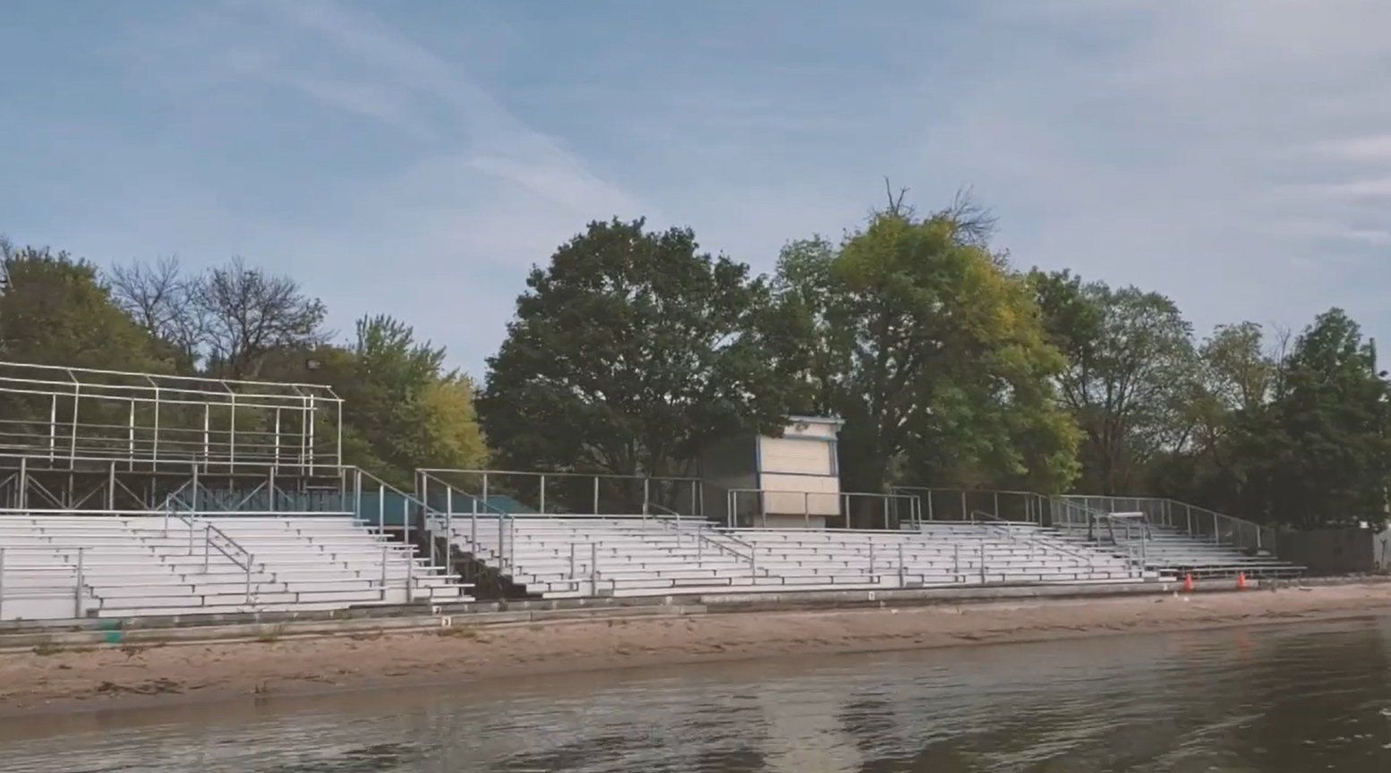 Empty bleachers next to the Rock River