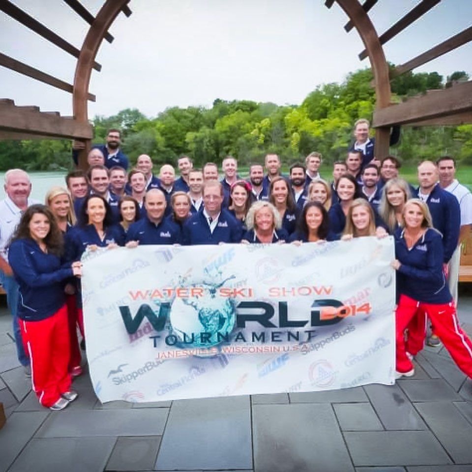 A group of people holding a sign that says World Tournament