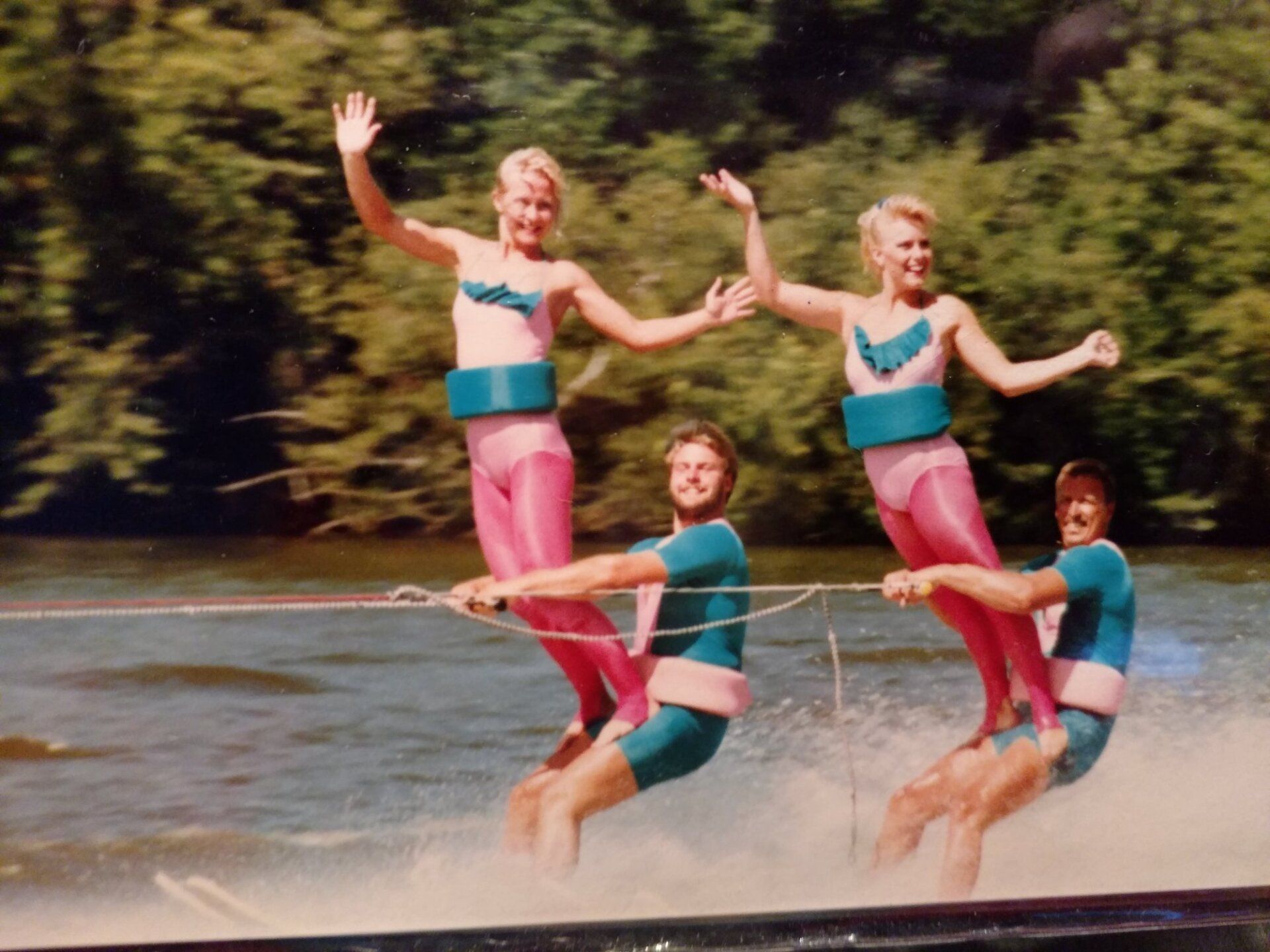 A group of people are water skiing on a lake