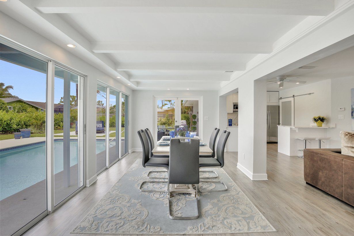 A dining room in a house with a table and chairs