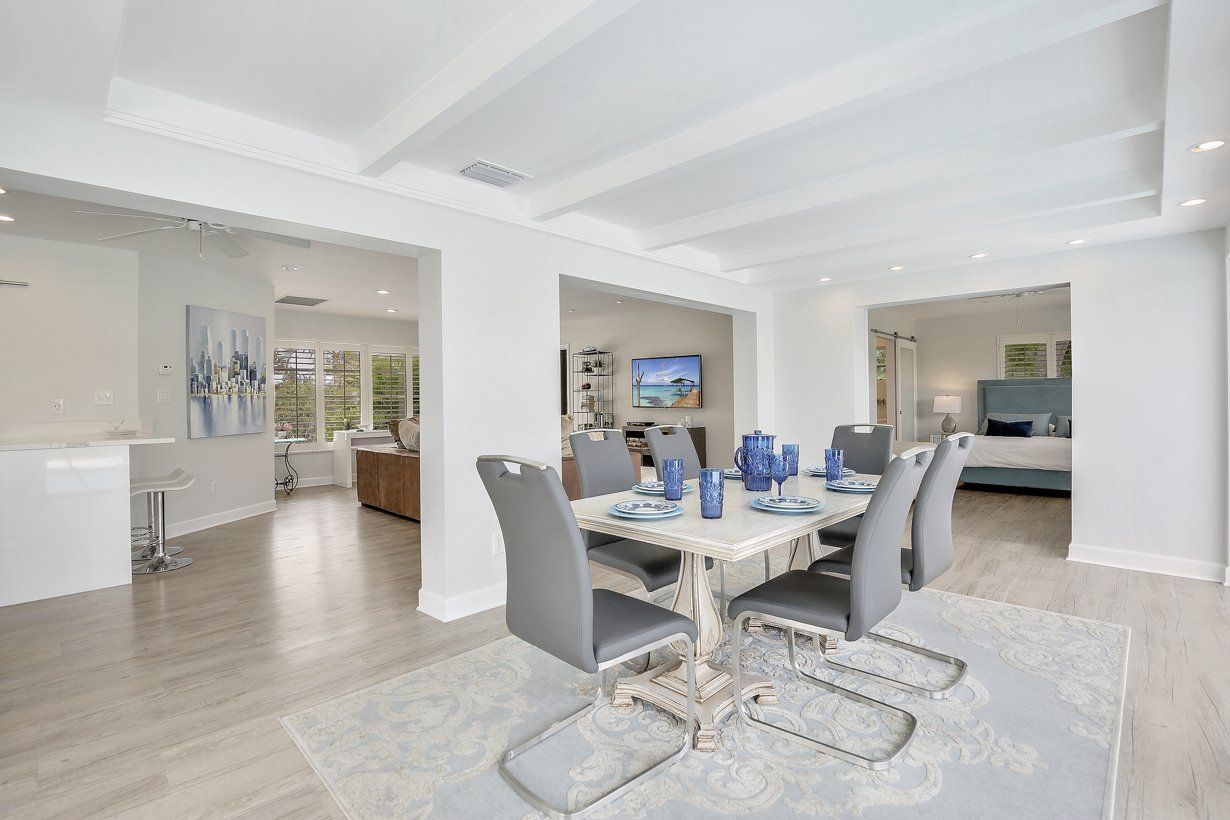 There is a dining room table and chairs in the middle of the room.