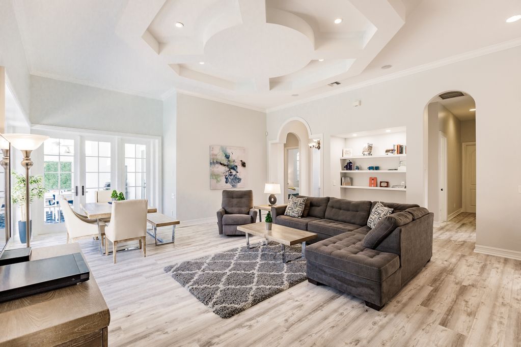 A living room with a couch , chairs , and a rug.