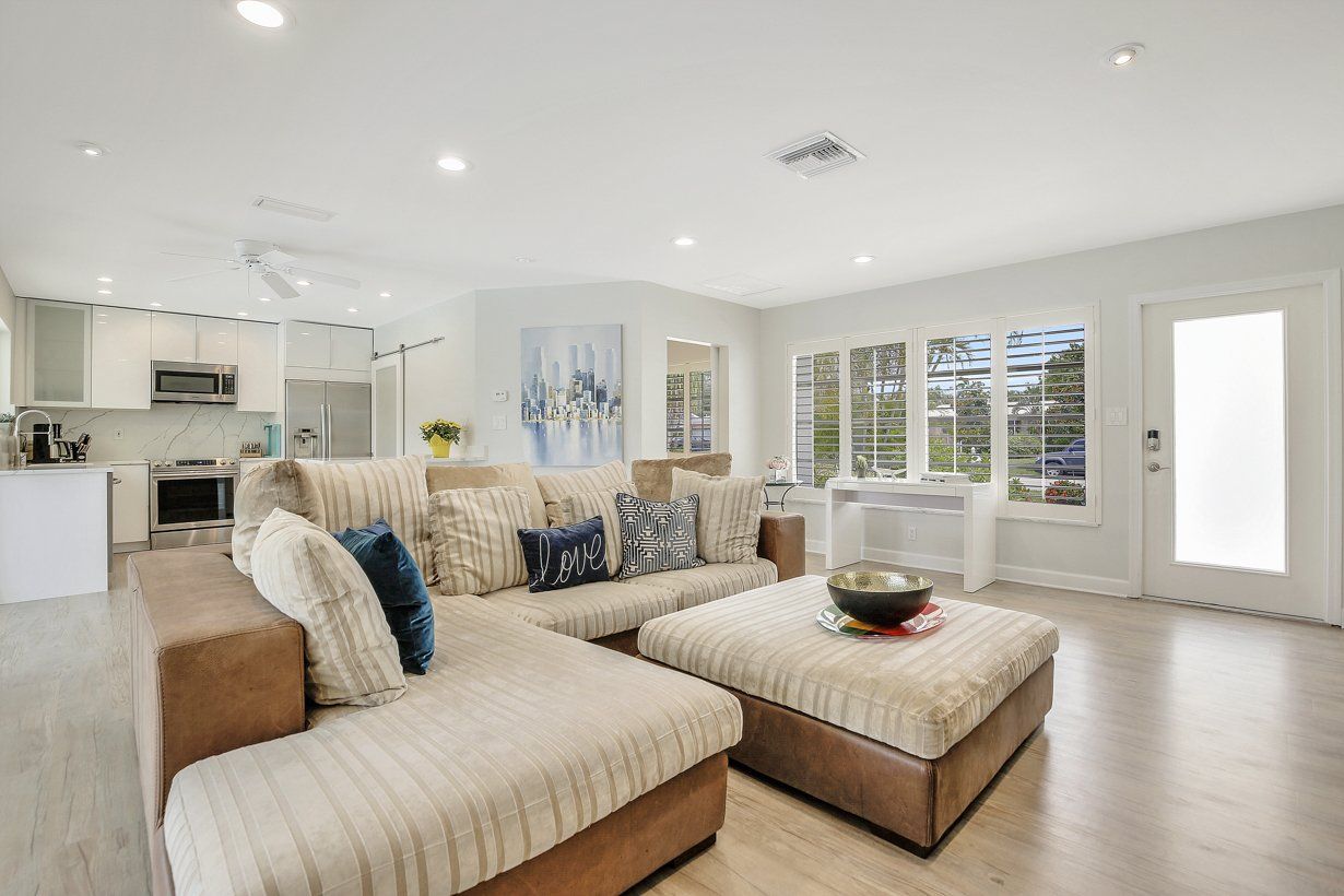 A living room filled with furniture and a large ottoman.