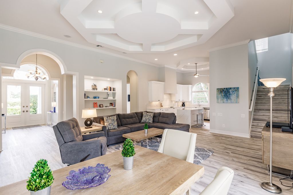 A living room with a dining table and chairs and a couch.