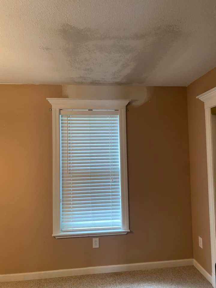 Construction workers at a wooden table reviewing blueprints. 