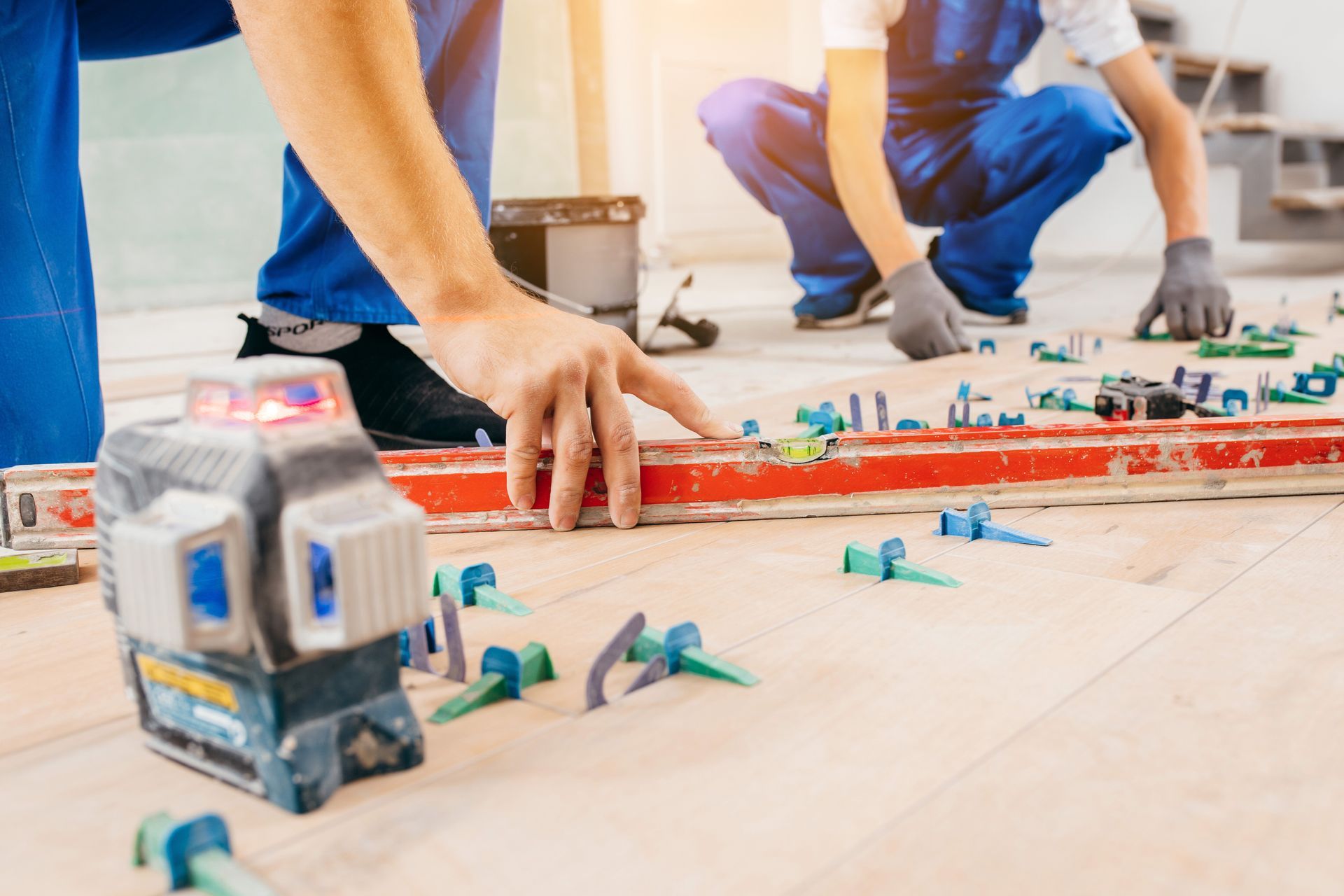 Construction workers at a wooden table reviewing blueprints. Construction workers at a wooden table reviewing blueprints.