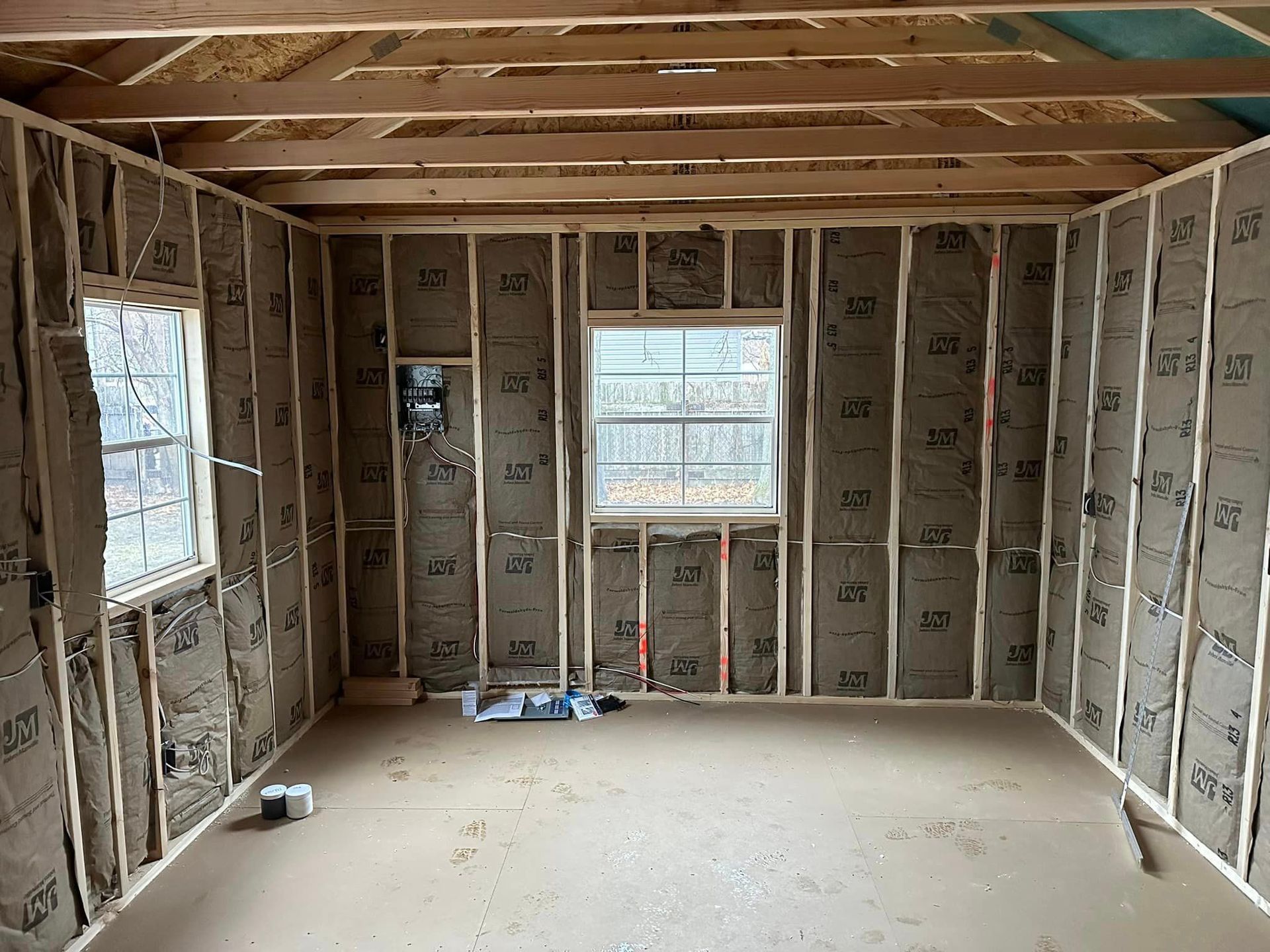 A room with a window and a lot of insulation on the walls.