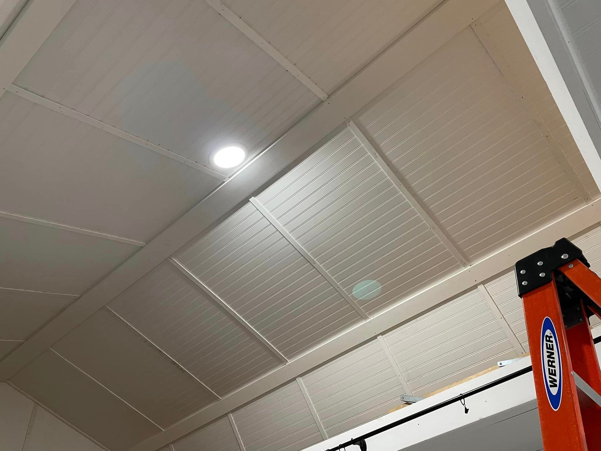 A ladder is hanging from the ceiling of a room.