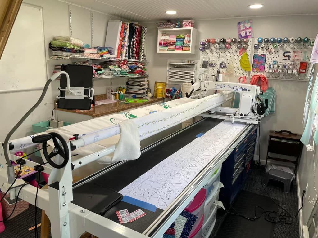 A sewing machine is sitting on top of a table in a room.