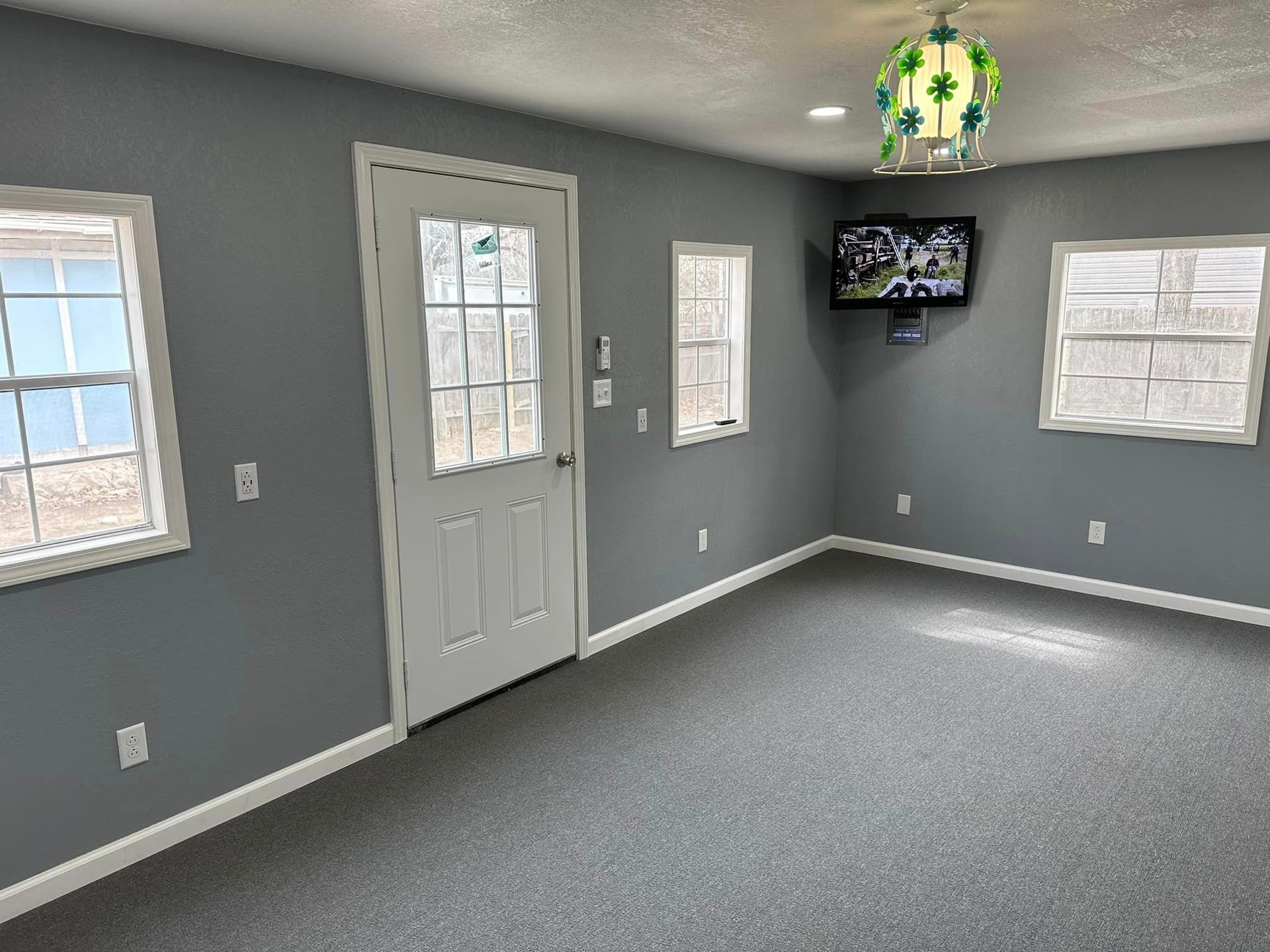 There is a television mounted on the wall in the living room.