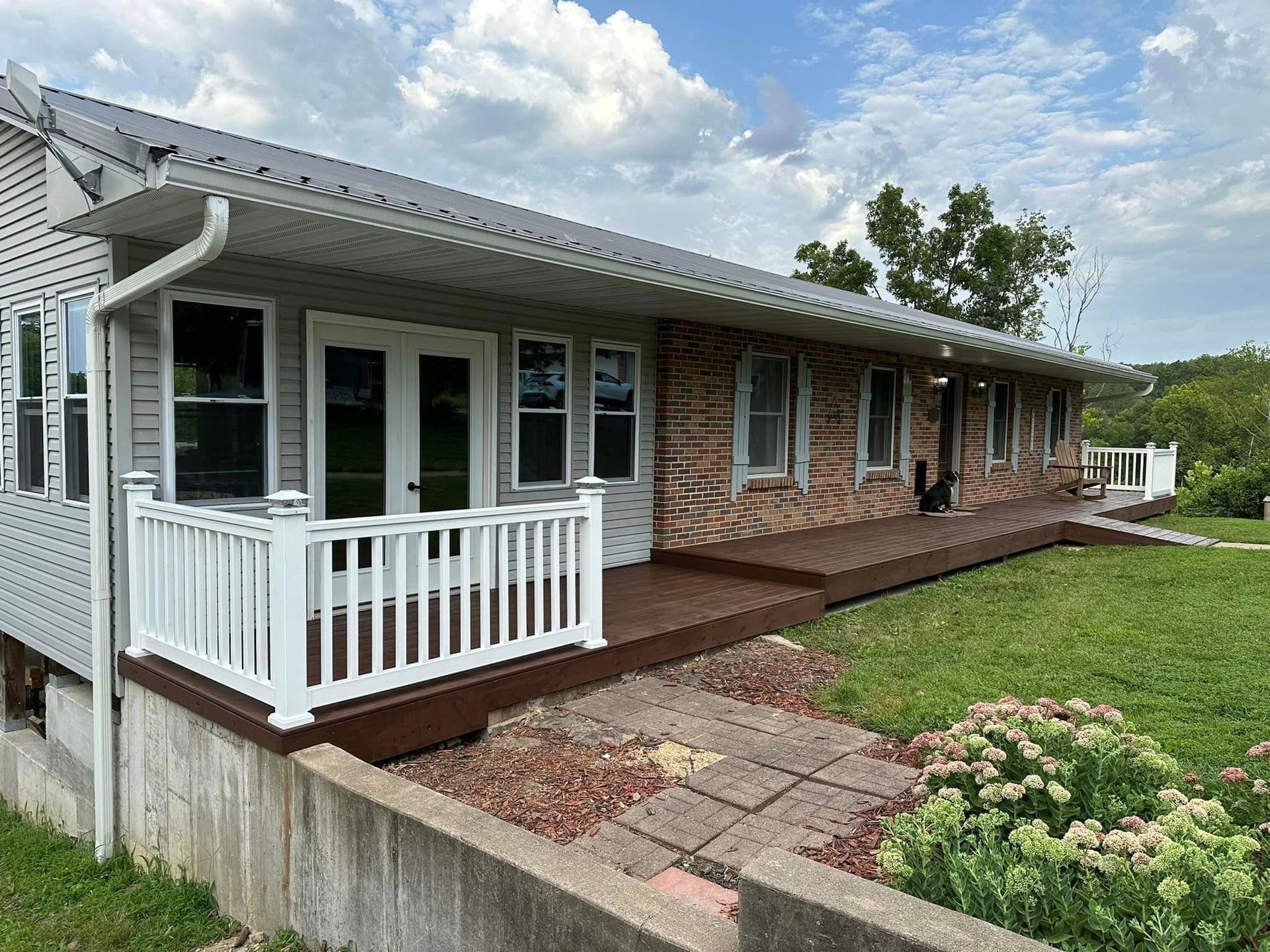 A house with a large porch and a white railing.