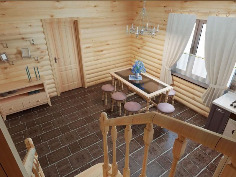 Una veduta aerea di una casa in legno con tavolo e sedie.